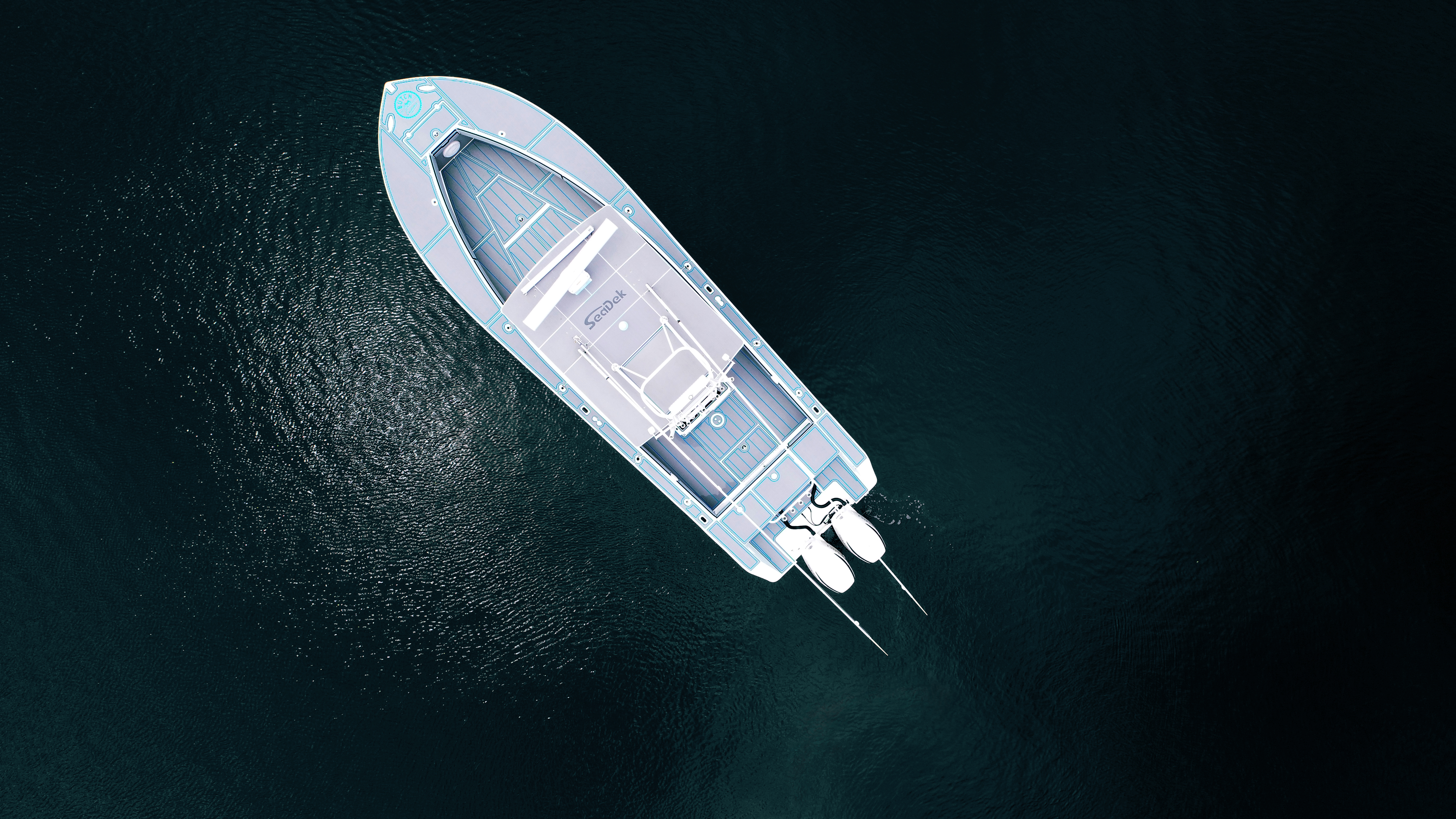 Drone shot of a regulator floating in the ocean. The regulator features a Storm Gray over Bahama Blue SeaDek kit with a custom logo at the bow of the boat.