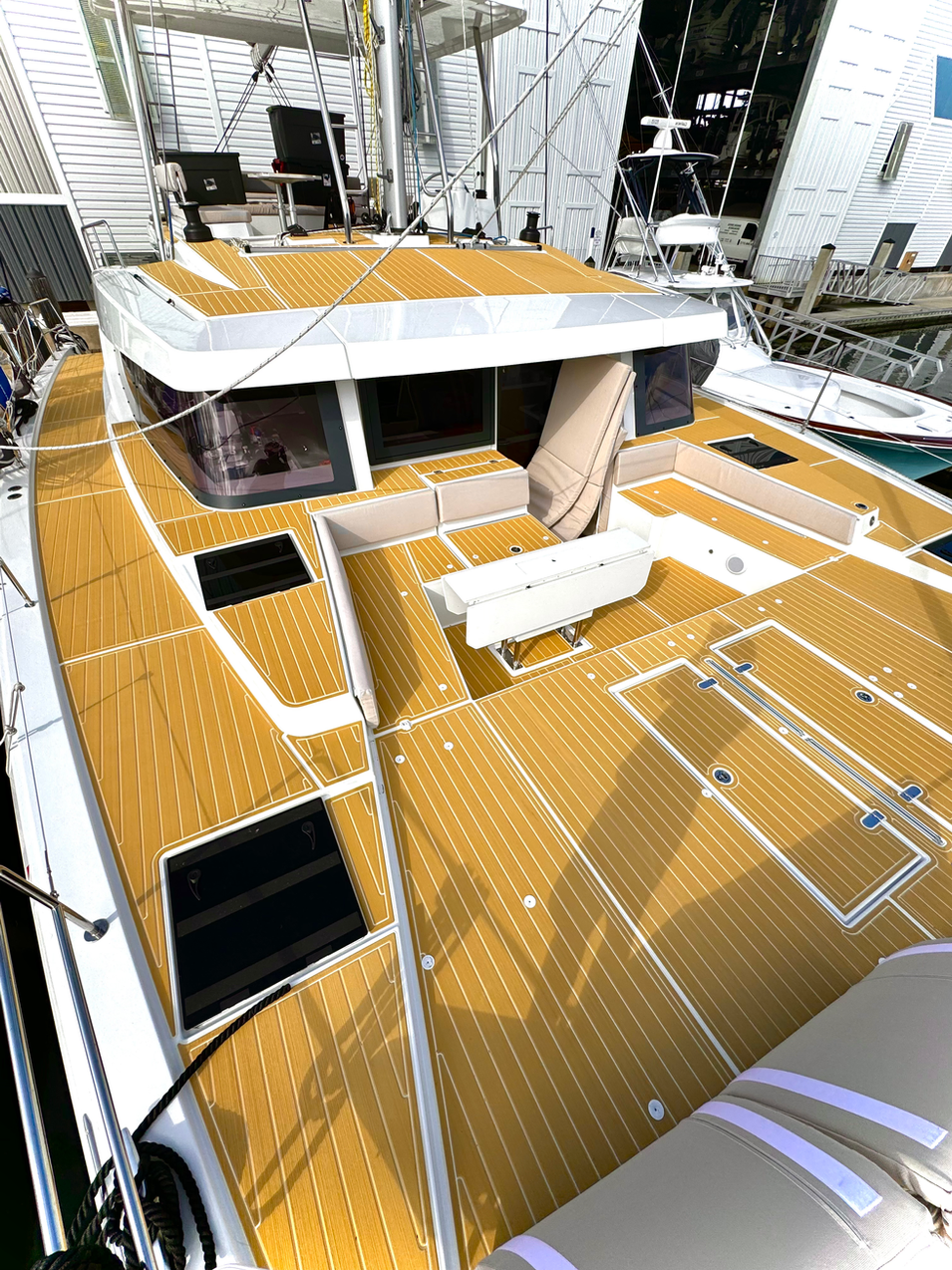 Custom SeaDek teak-style boat flooring installed on catamaran yacht by MarineDex in Florida
