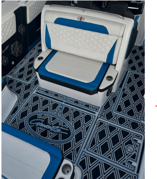 Boat seating area with custom black and blue SeaDek flooring featuring detailed laser-engraved geometric patterns and an engraved logo design. seadek lifespan florida.