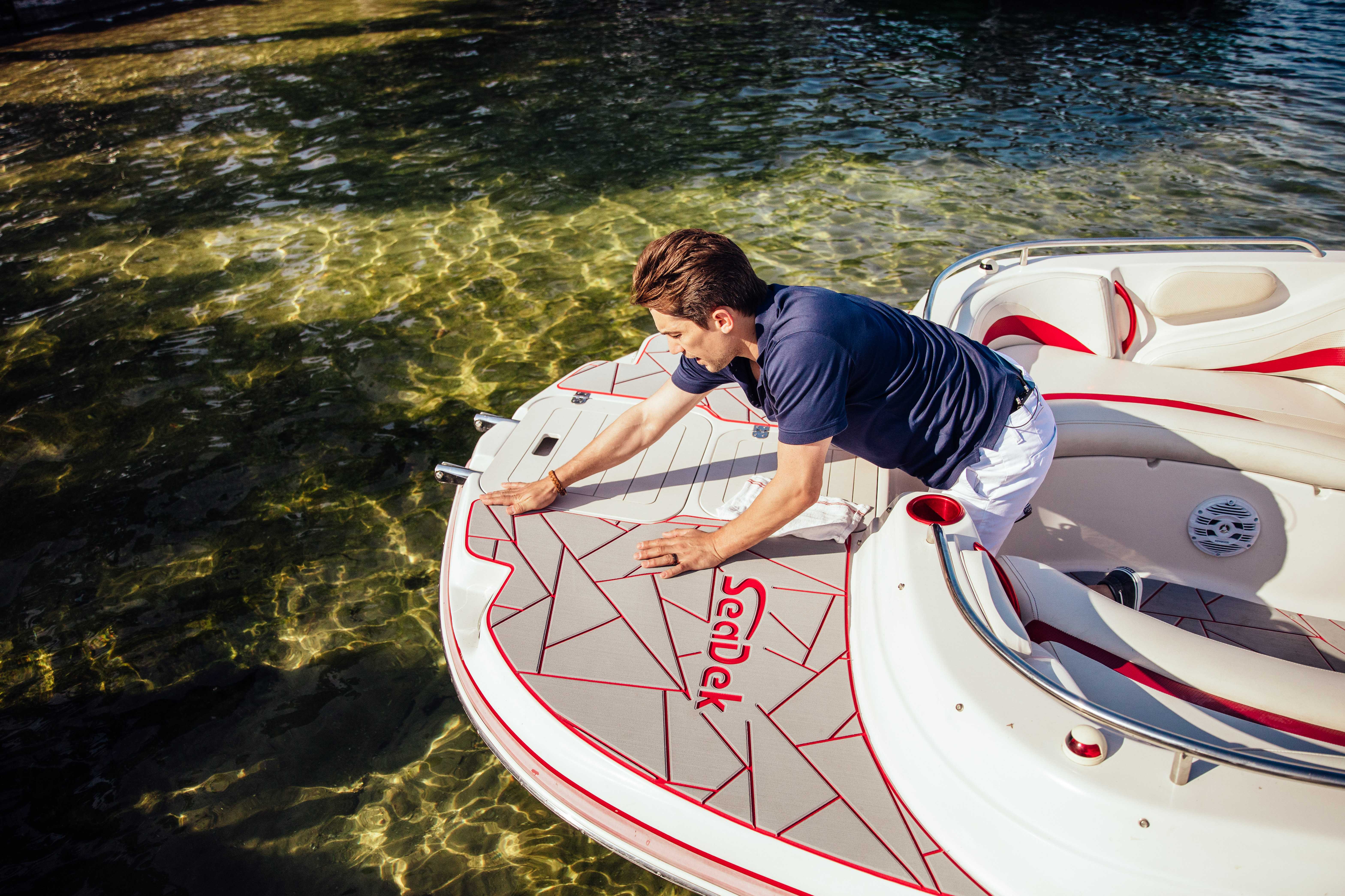 Custom SeaDek boat flooring with blue routed accents on a light deck design