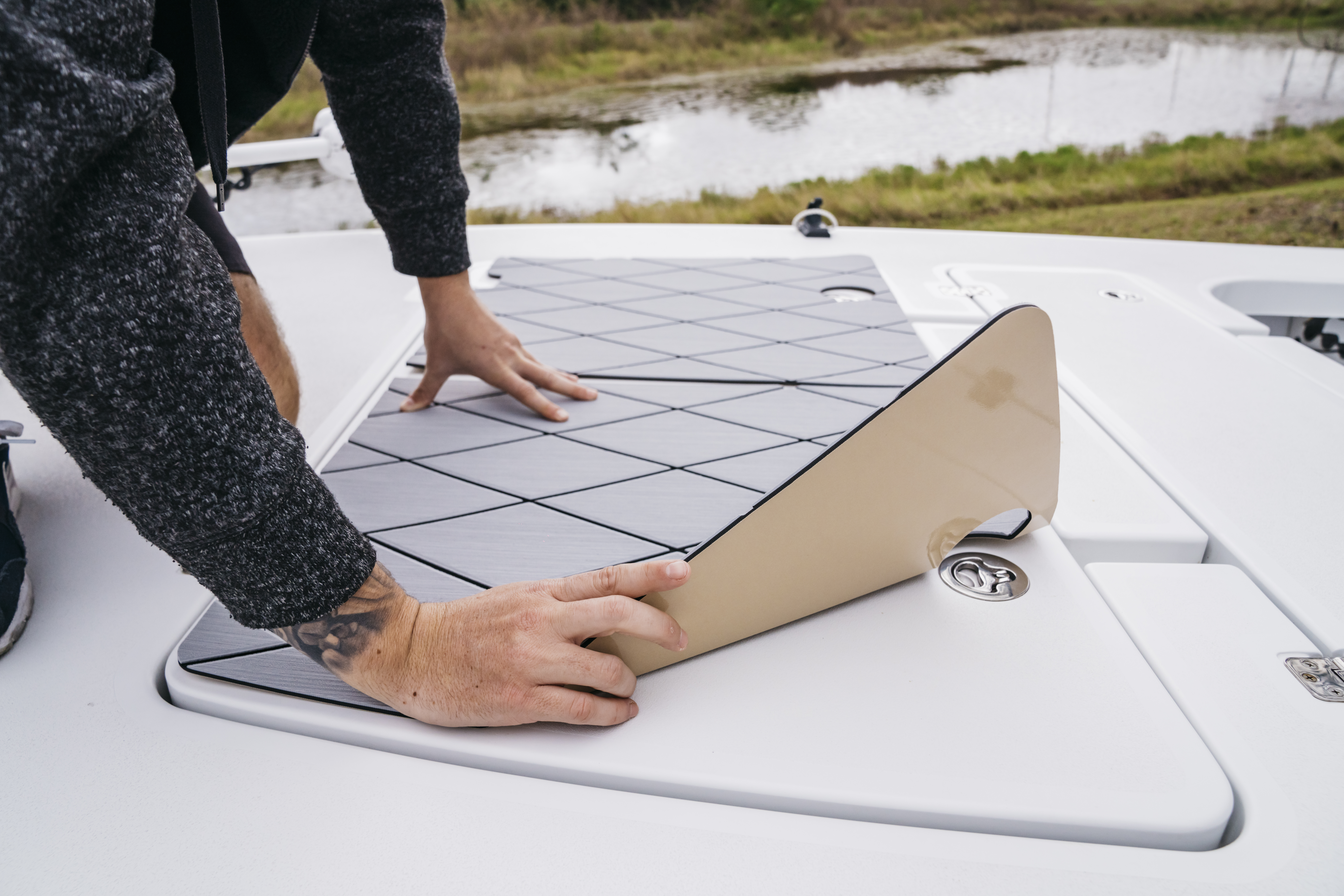 Peel and stick backing applied during SeaDek boat flooring installation process