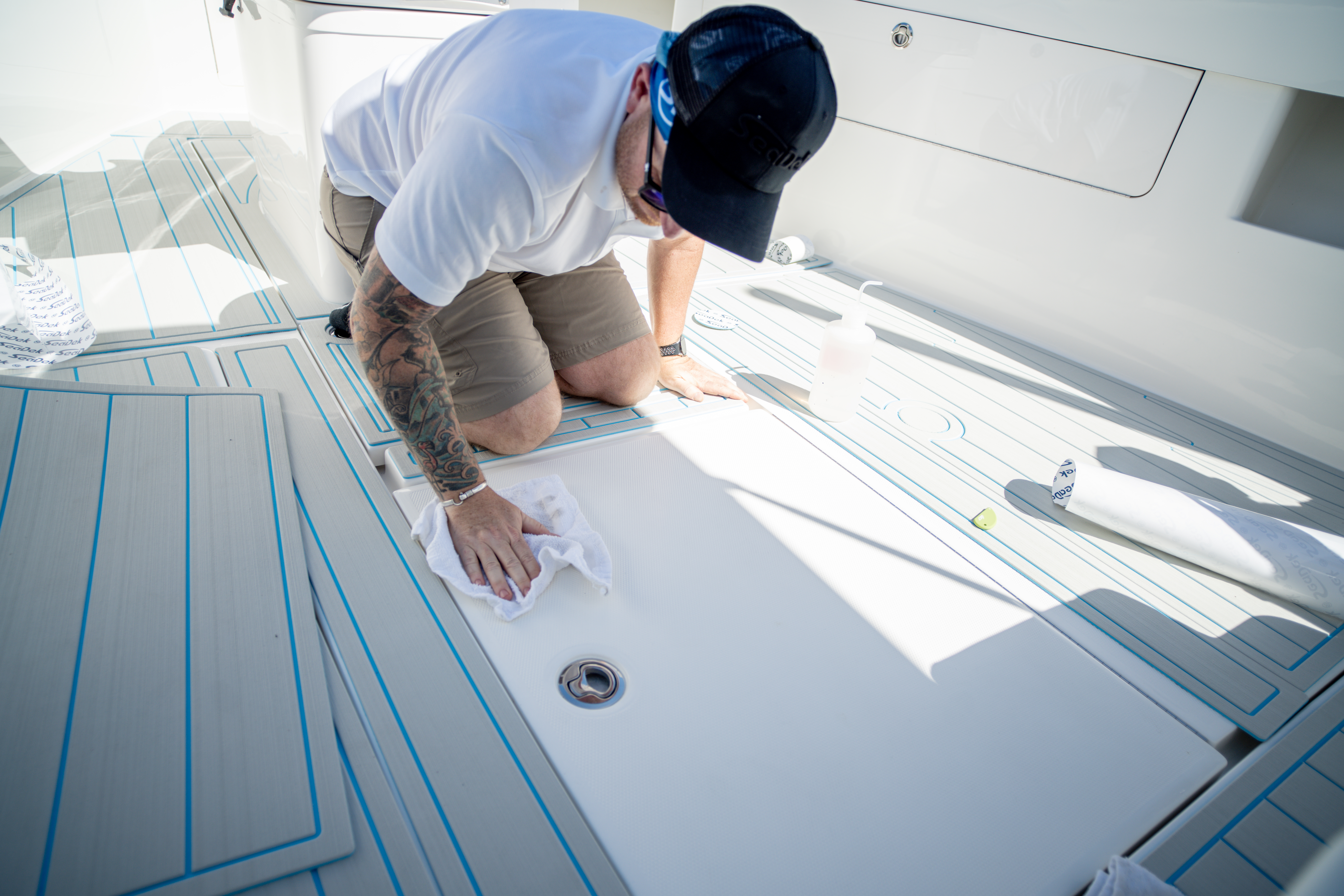 MarineDex technician templating a boat deck for custom SeaDek boat flooring installation